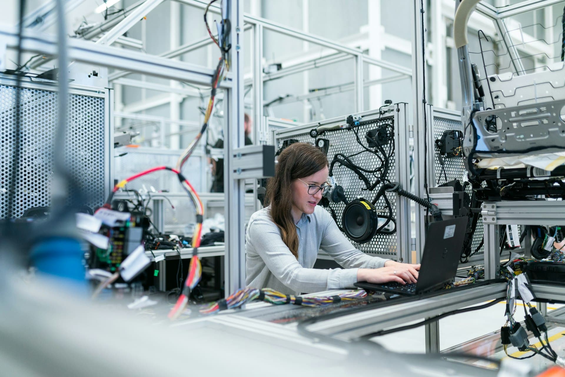 Operator at a laptop in a tech lab setup