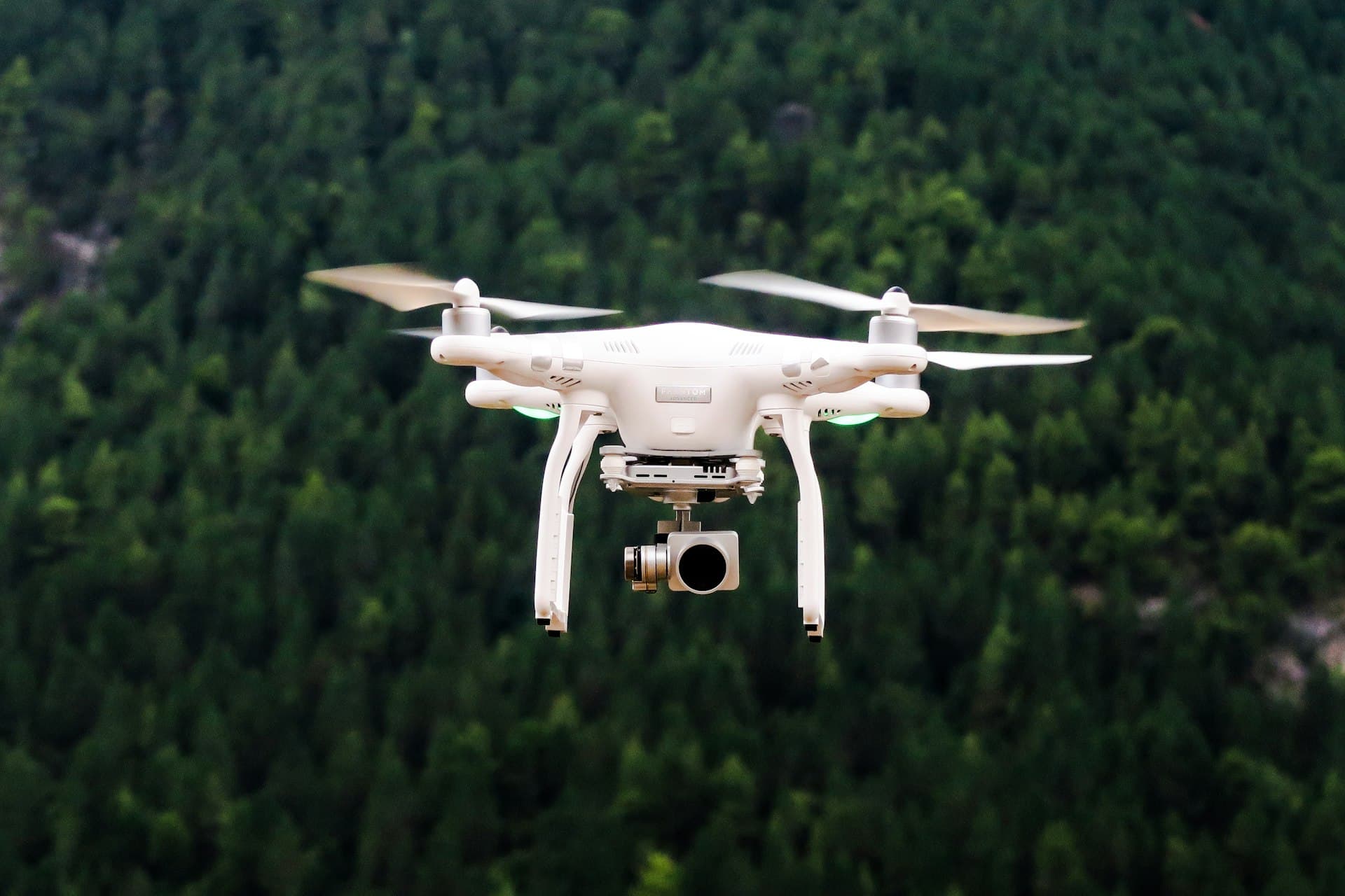 Survey drone hovering over a forest canopy